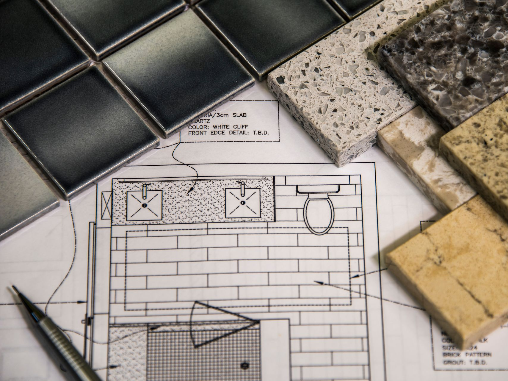 Bathroom design plan with tile and countertop samples.