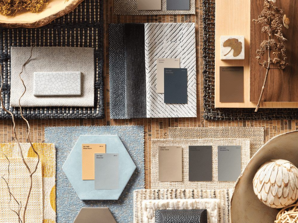 Mood board with textured fabrics, wood, and paint swatches in neutral tones.