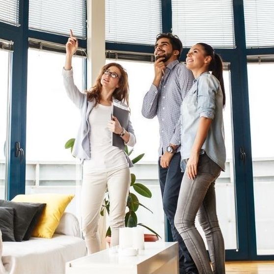 Picture of designer, samples, colors, and fabrics work with a young couple.
