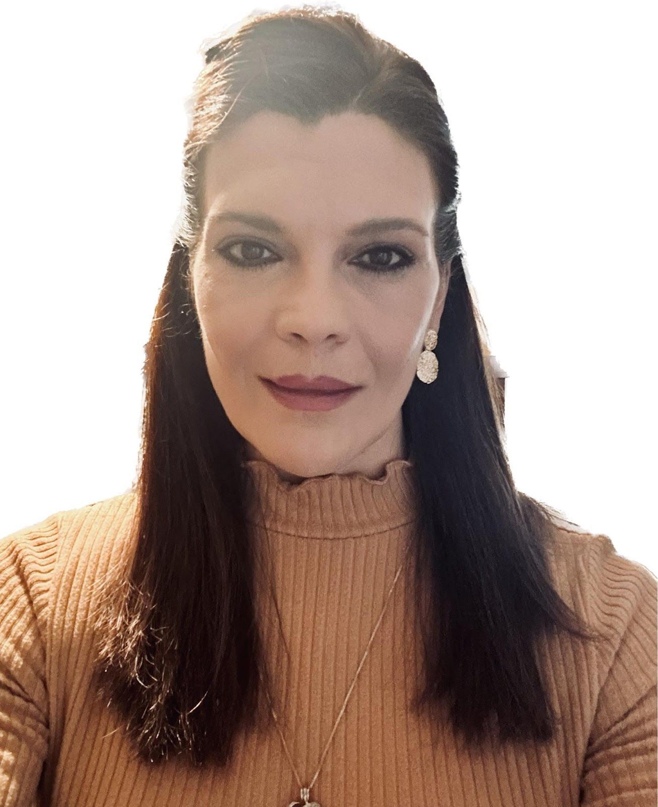 A woman is wearing a brown sweater and earrings