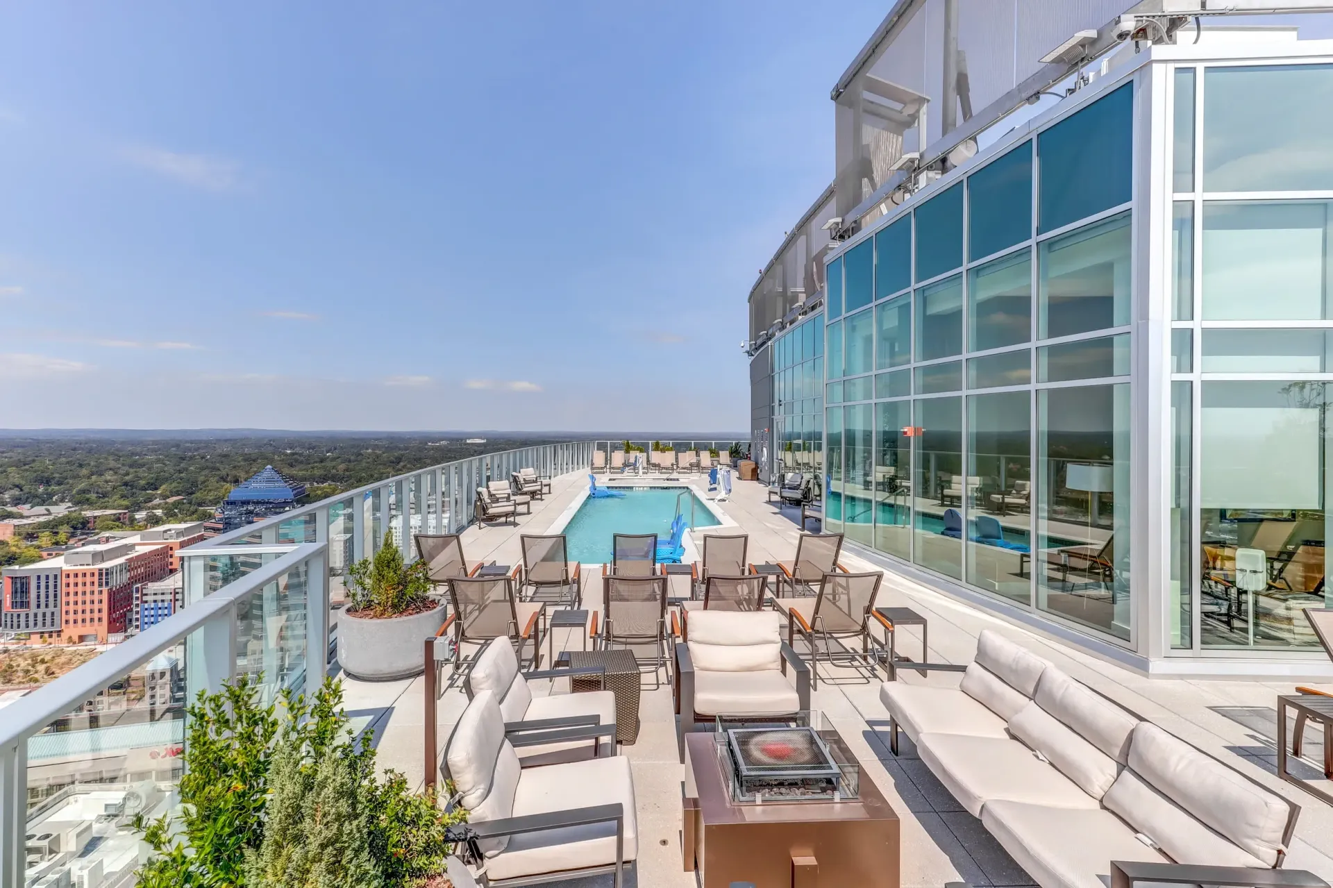 Rooftop pool and lounge area with city views