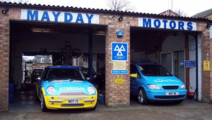 mayday motors garage with two cars parked