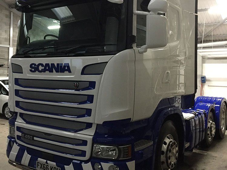 Front of a white SCANIA HGV.