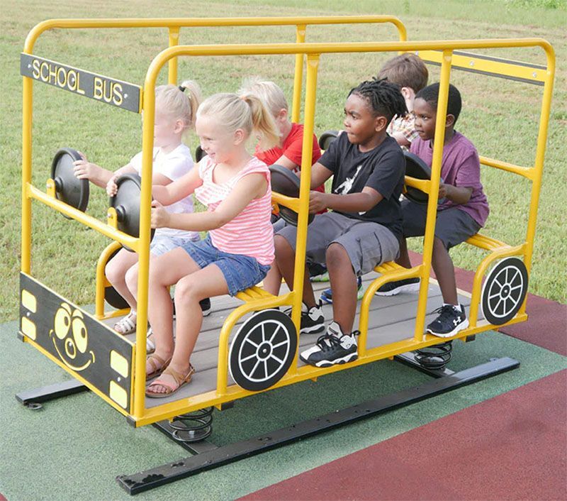 A group of children are riding on a yellow school bus