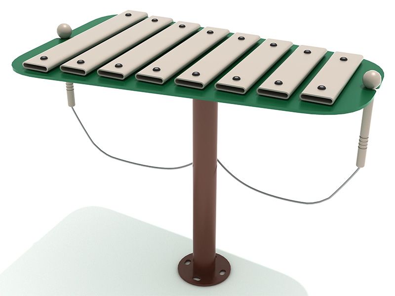 A xylophone is sitting on top of a green table.