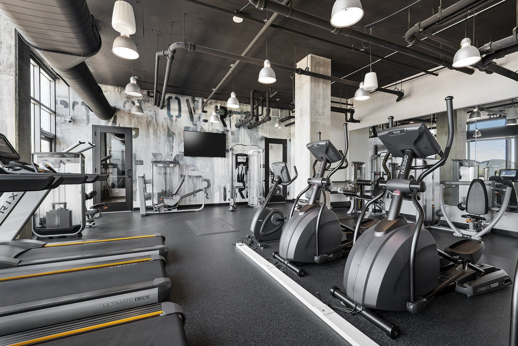 A gym with a lot of exercise equipment including treadmills and ellipticals at Reside on Green Street.