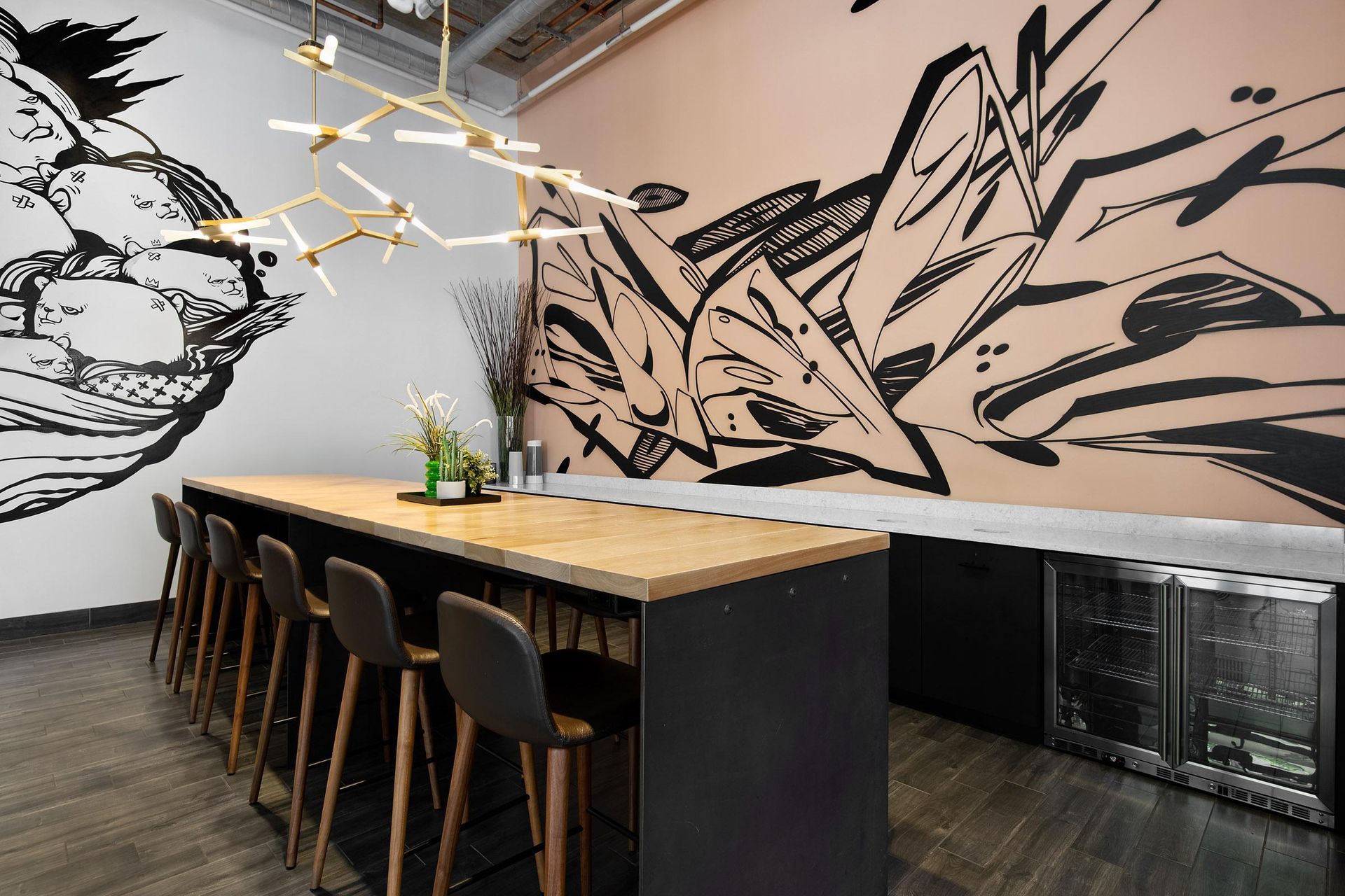 a dining room with a long table and chairs in front of a mural