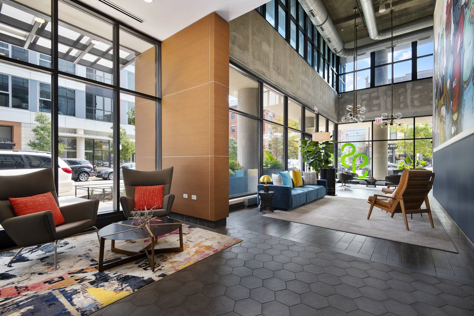 A large lobby with a lot of windows and furniture at Reside on Green Street.