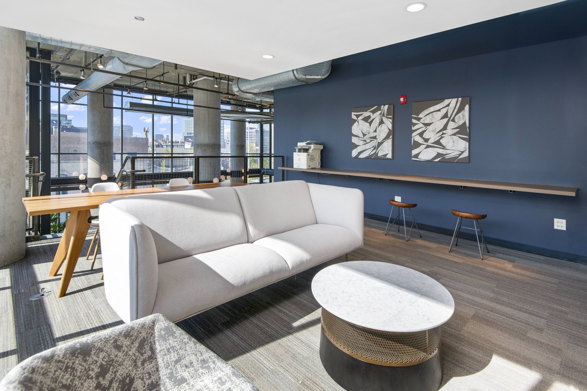 a living room with blue walls and a white couch and a table