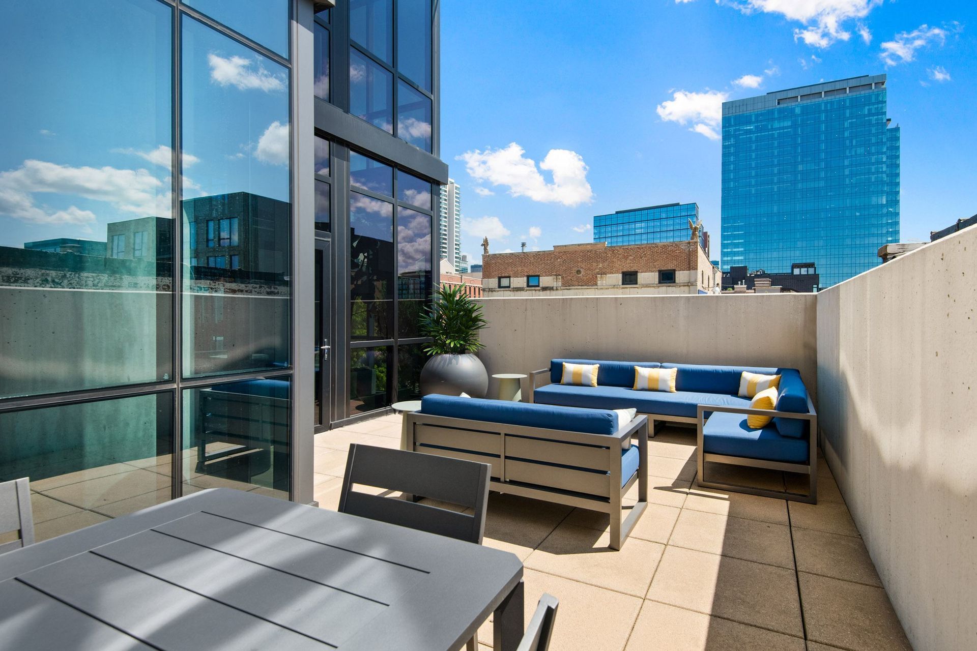 a rooftop patio with a table and chairs