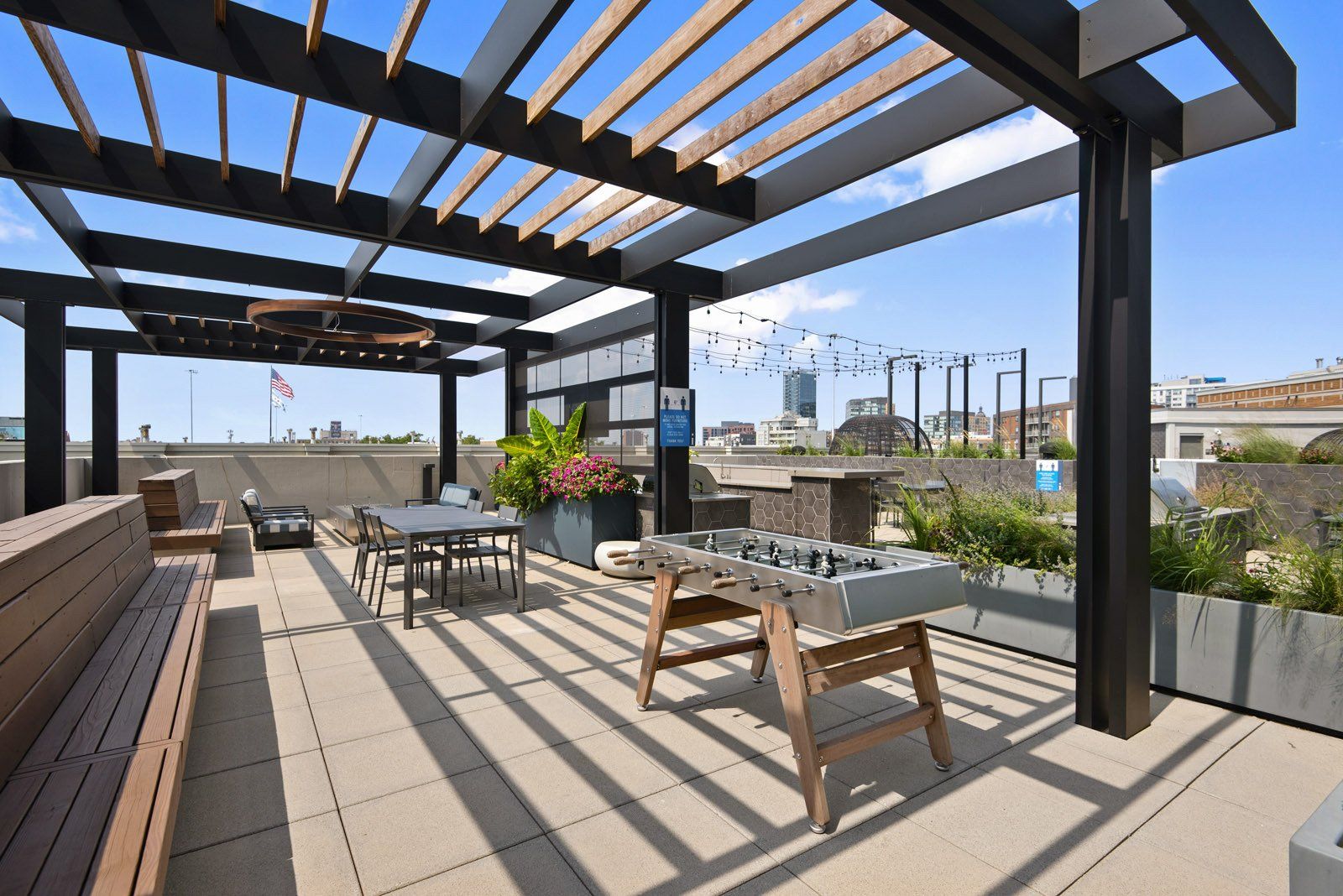 A patio with a table and chairs under a pergola at Reside on Green Street.