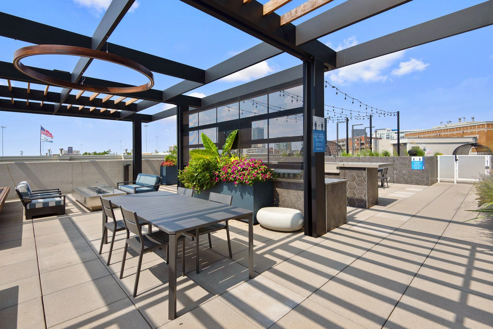 A patio with a table and chairs under a pergola at Reside on Green Street.