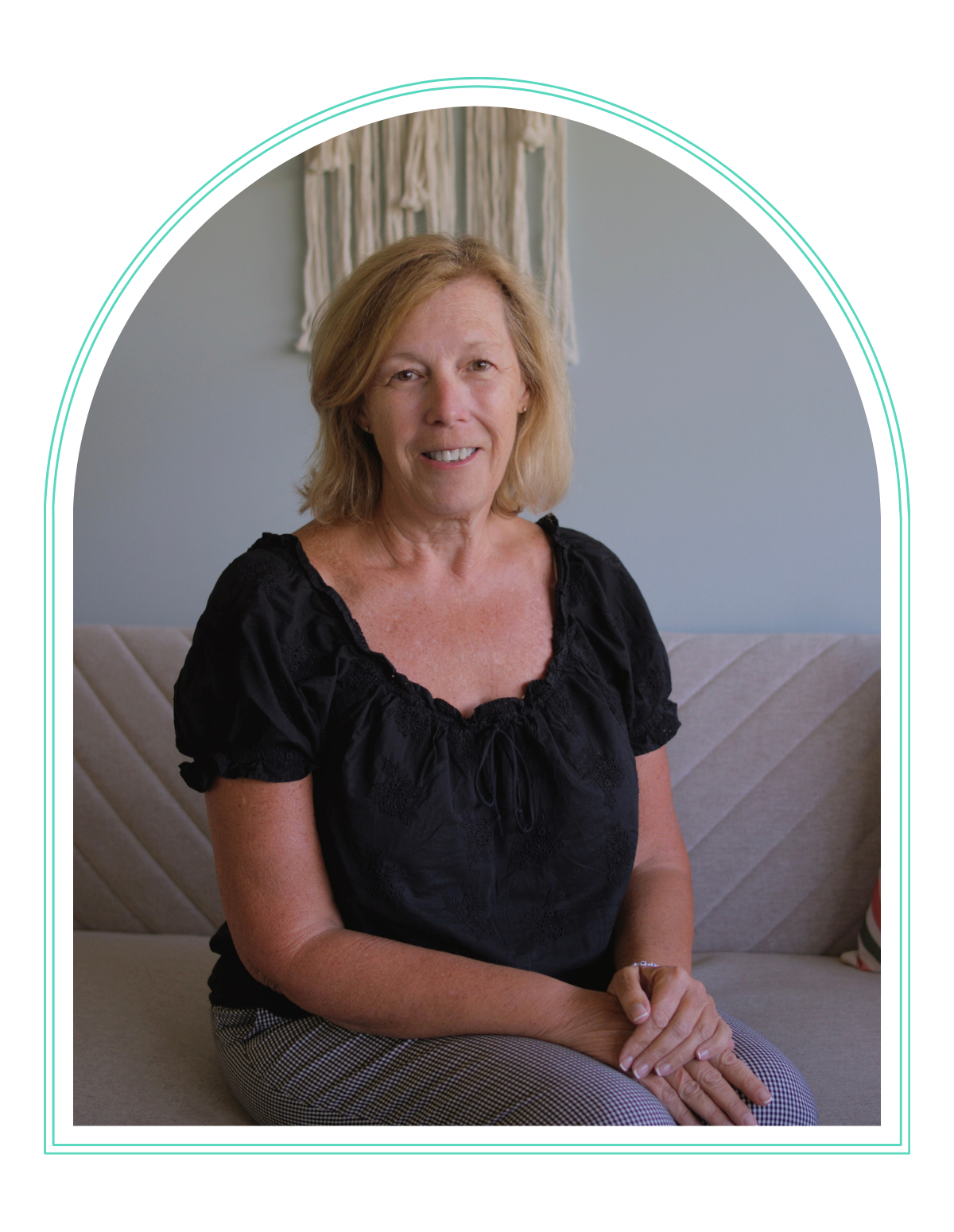 a woman sits in a chair with a stack of magnets on a table