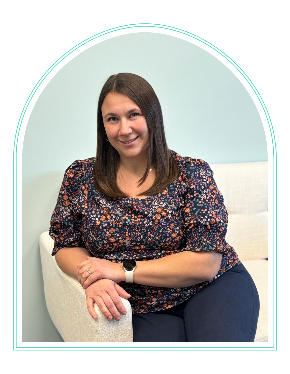 a woman in a pink shirt smiles for the camera