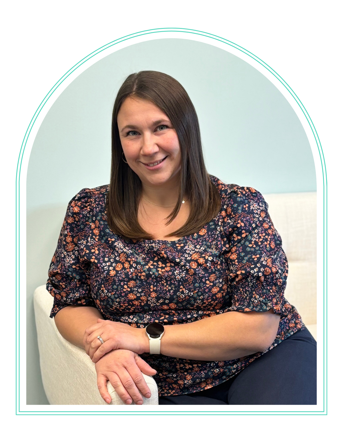 a woman in a pink shirt smiles for the camera