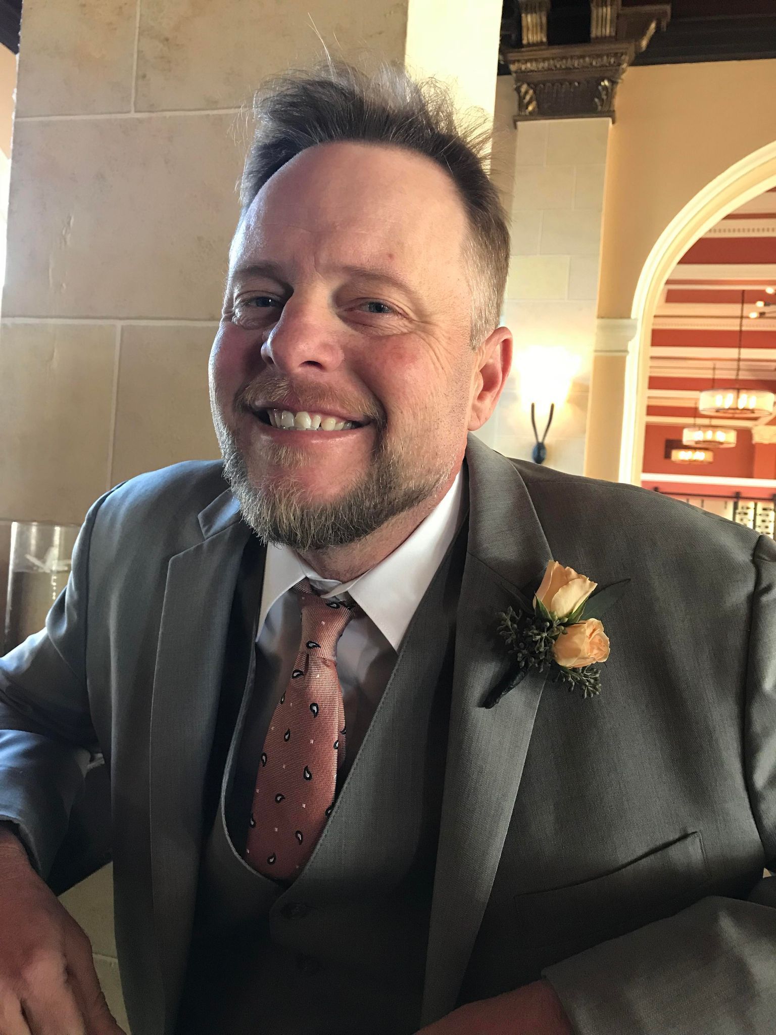 Jason Vasconi wearing a suit posing for a photo