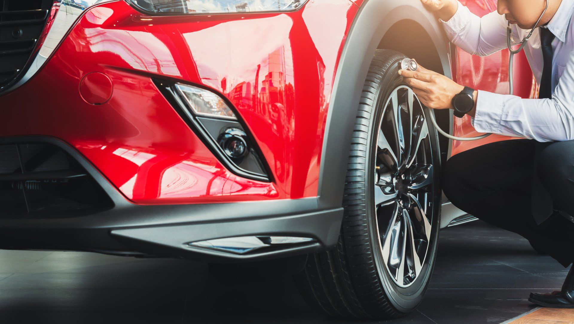 doctor checking on car tire with stethoscope