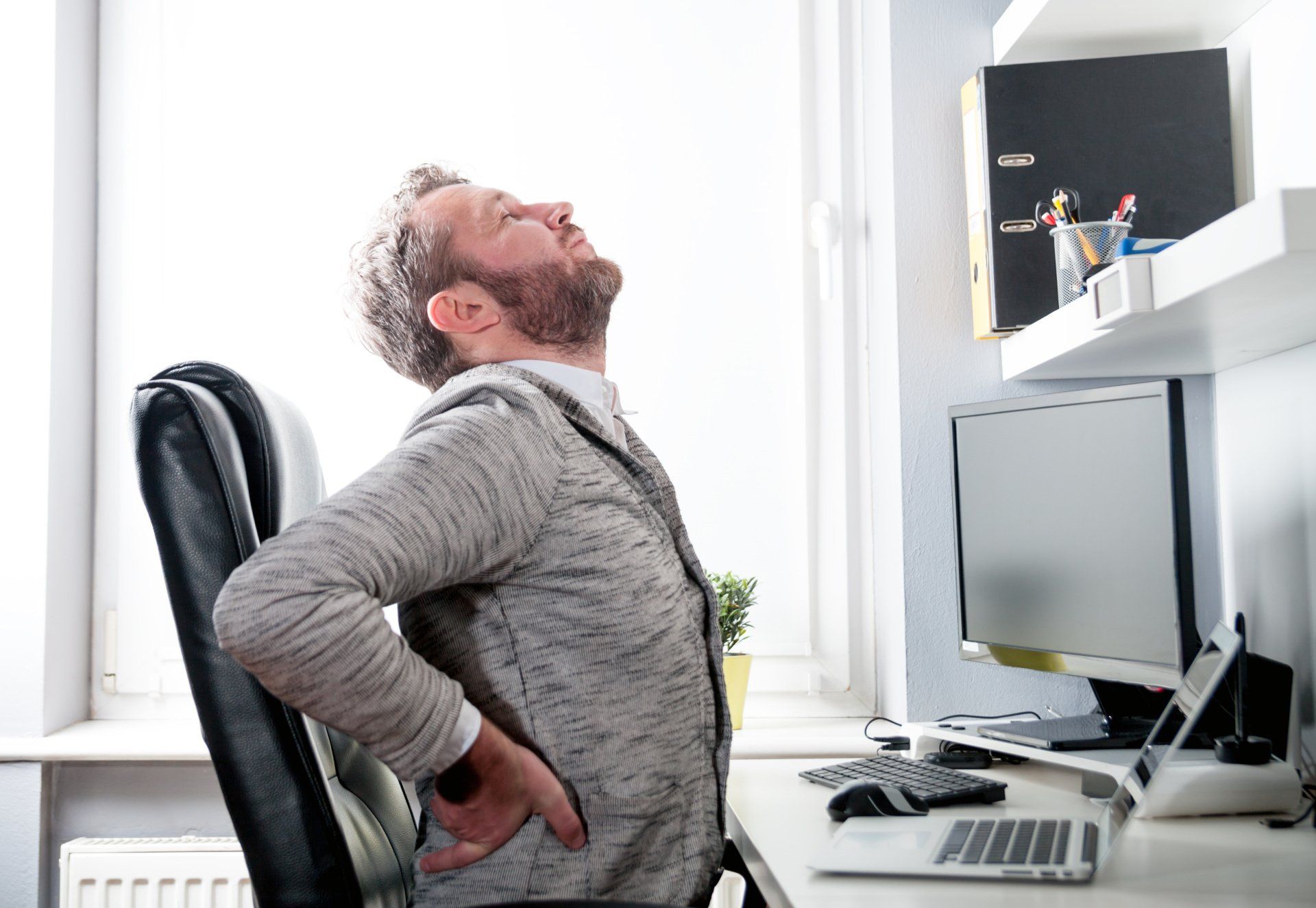 man at computer with hurting back