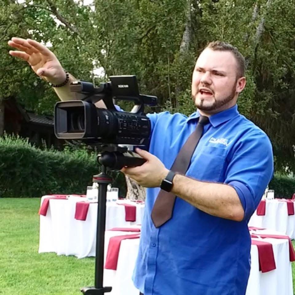 Travis Bertram filming a production with a Sony camcorder back ini 2015