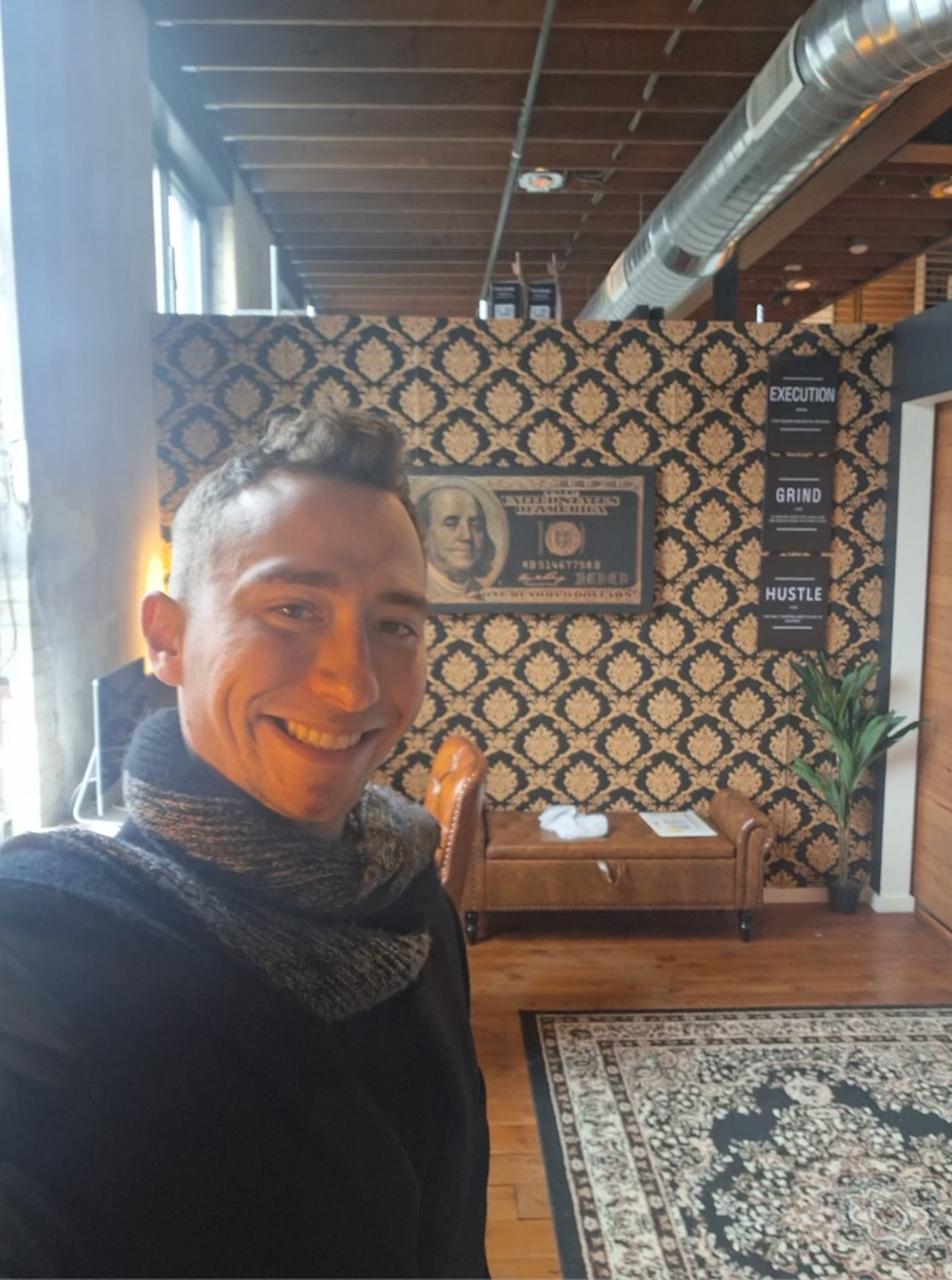 Isadore Goldsein in suit speaking at a podium, large cross in background, audience silhouetted.