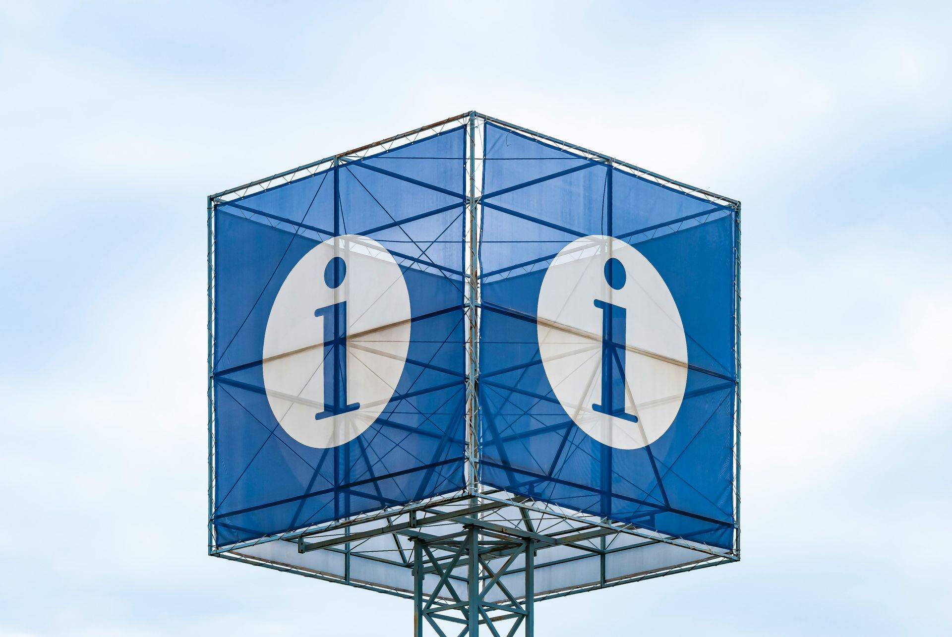 Blue cube-shaped information sign with white