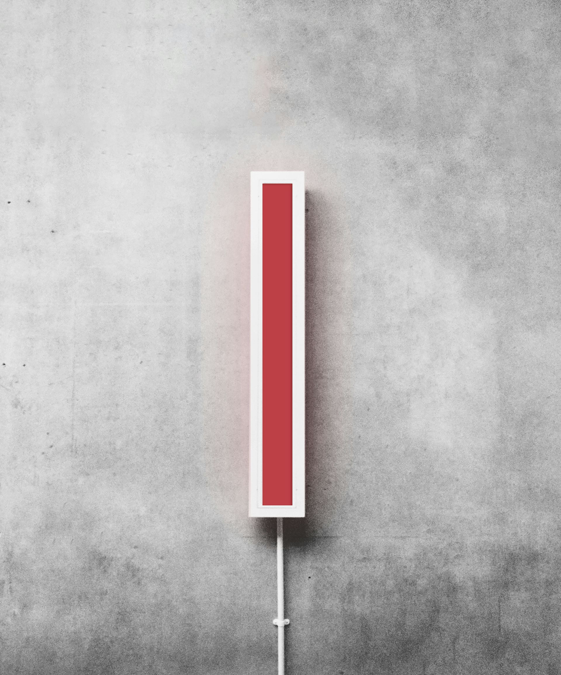 Red and white rectangular light on a gray concrete wall.