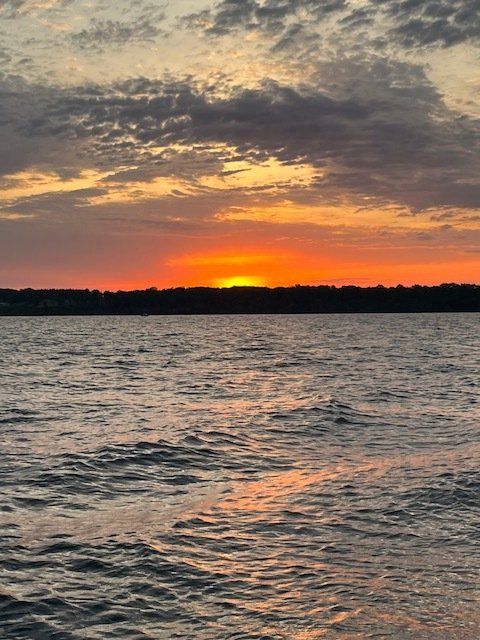 The sun is setting over a large body of water.