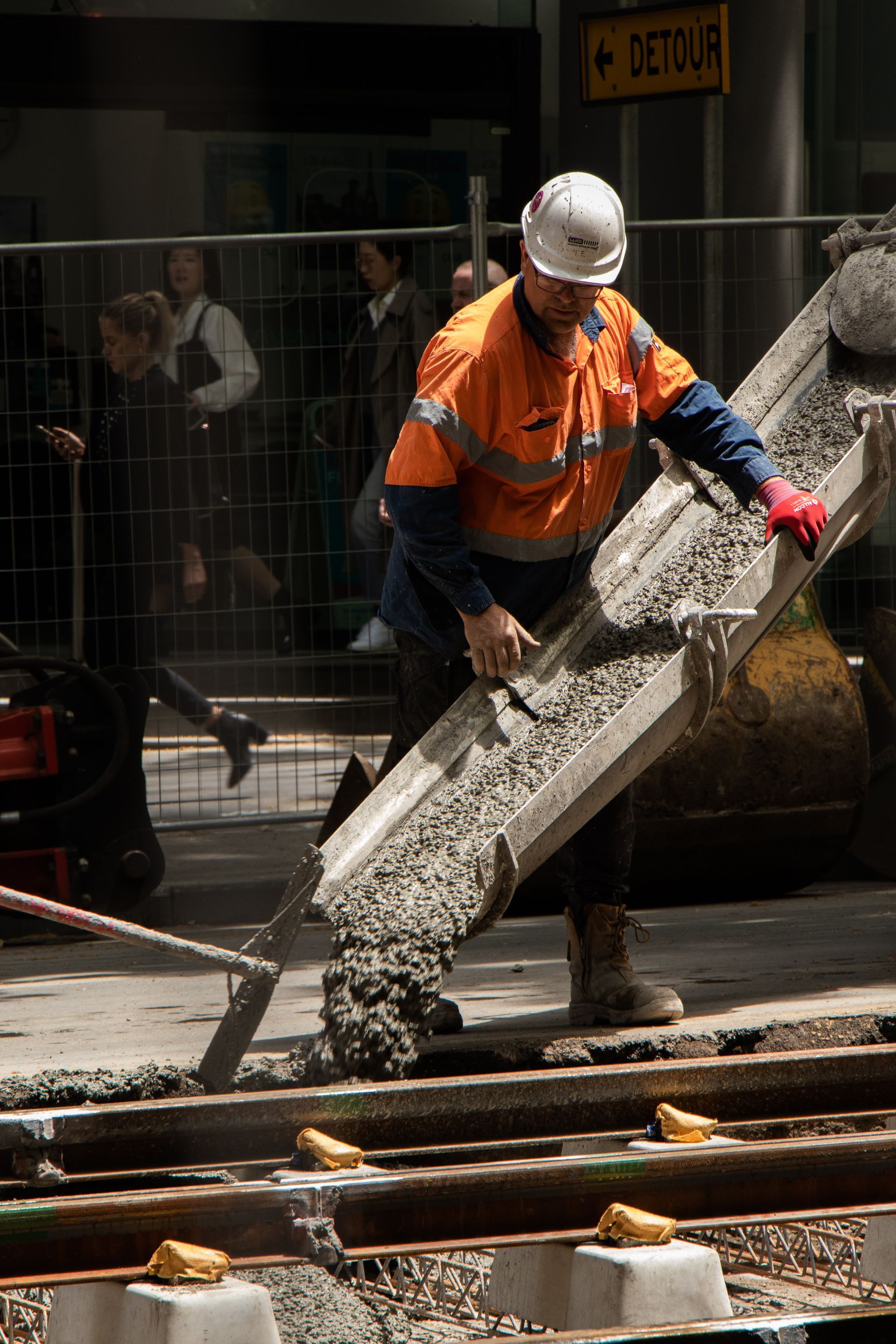 man applying stucco to a grey wall