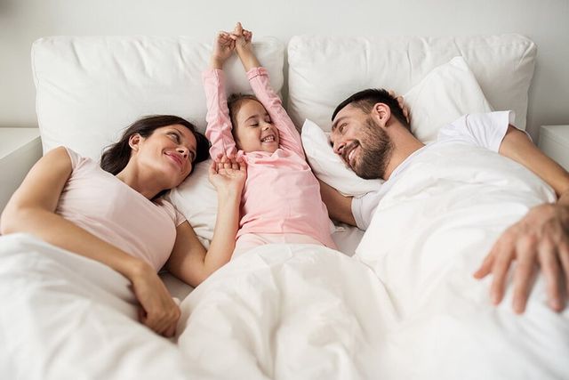 Happy Family in Bed — Natraspray in Coffs Harbour, NSW