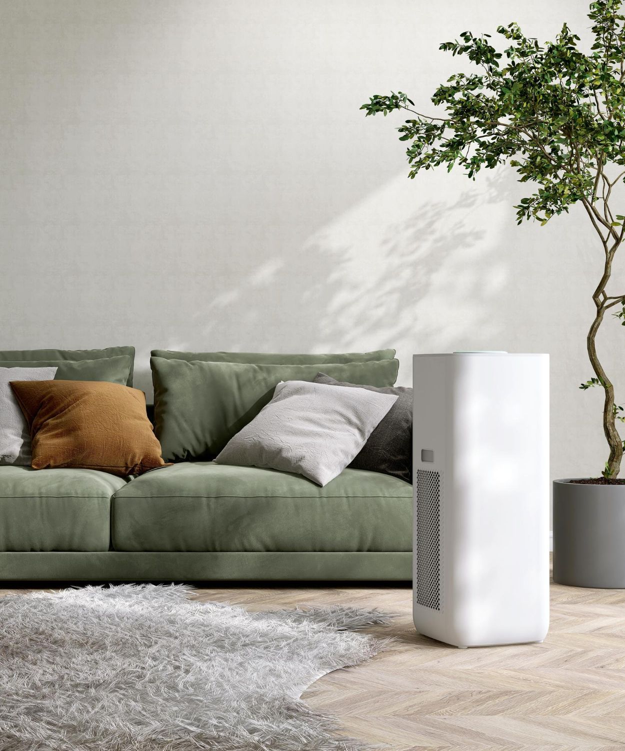 White air purifier in modern living room with green sofa, pillows, and a plant.