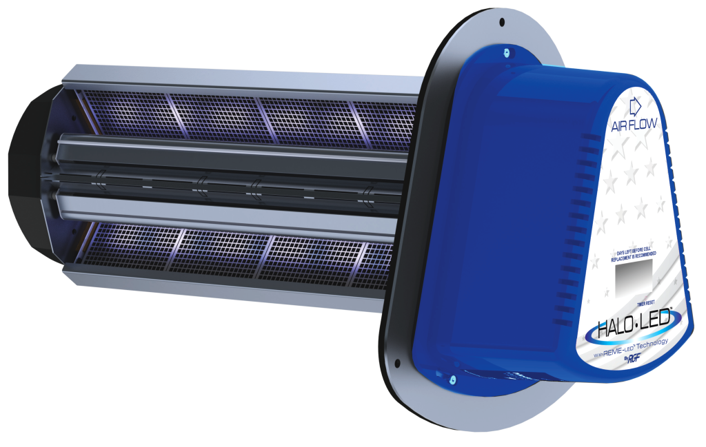 Air purifier in a living room; a woman reads on a couch, a dog lies nearby.