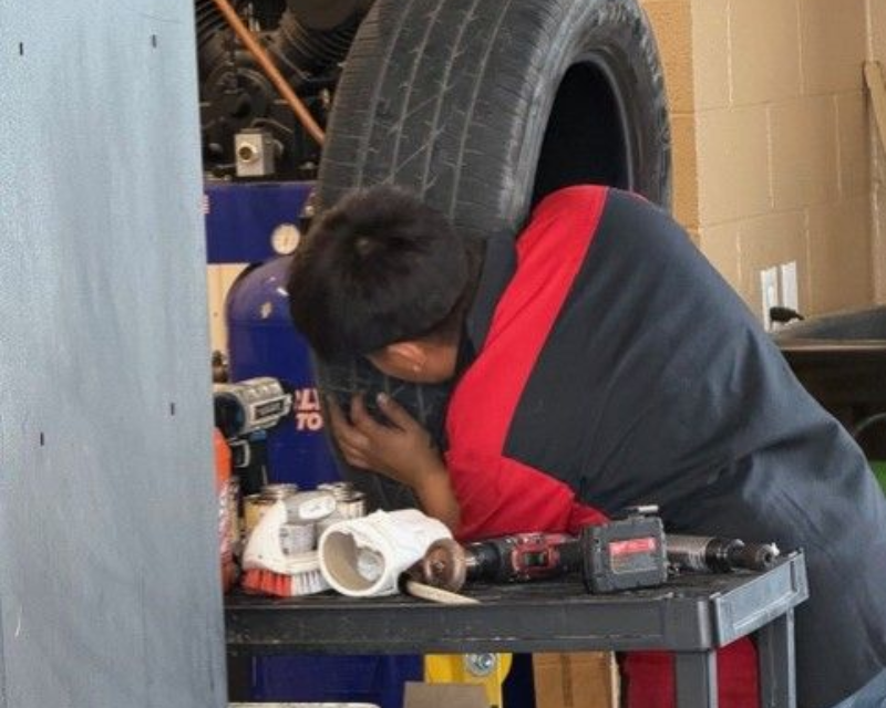 Technician Working Near Tire And Tools | Locals Automotive Repair