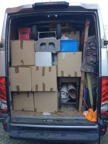 neatly boxed and packaged items by client stacked in van small move