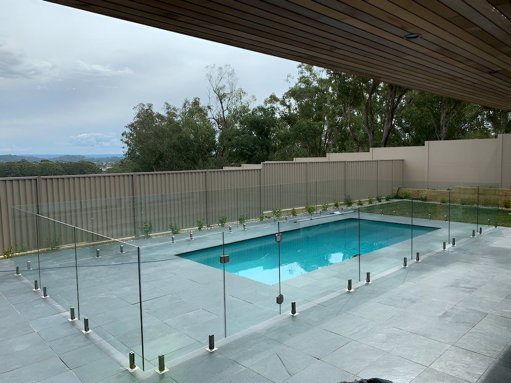 A Large Swimming Pool Surrounded by a Glass Fence — All Glass Balustrading Systems in Manly, NSW