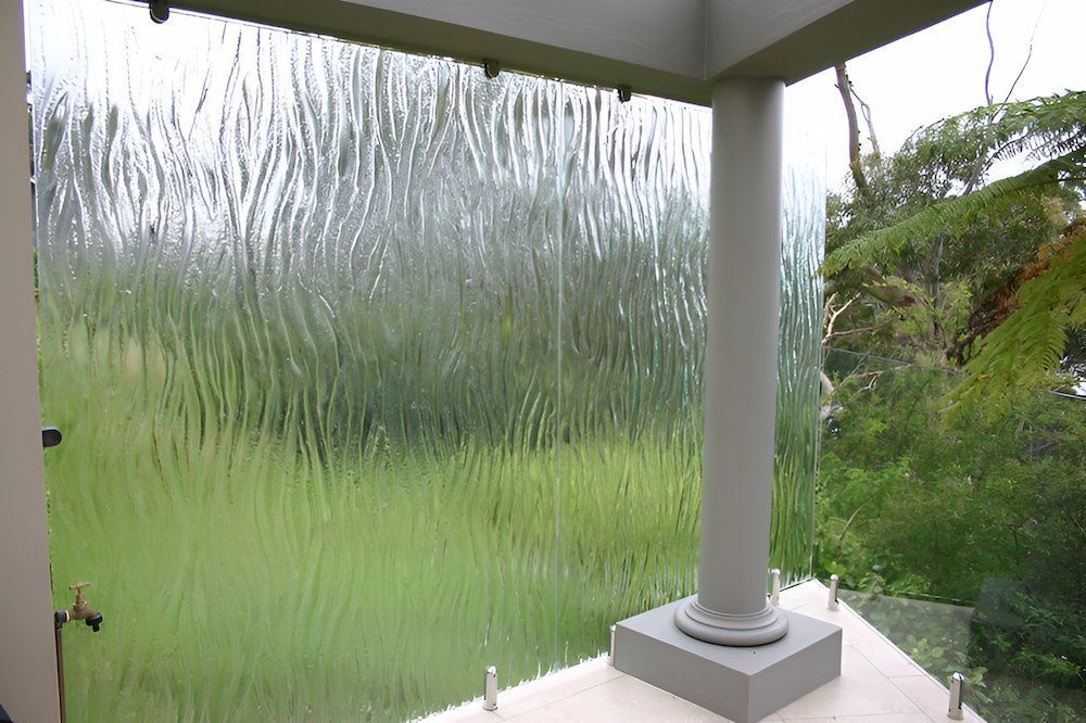 A Balcony With a Glass Wall and a View of a Field — All Glass Balustrading Systems in Wetherill Park, NSW