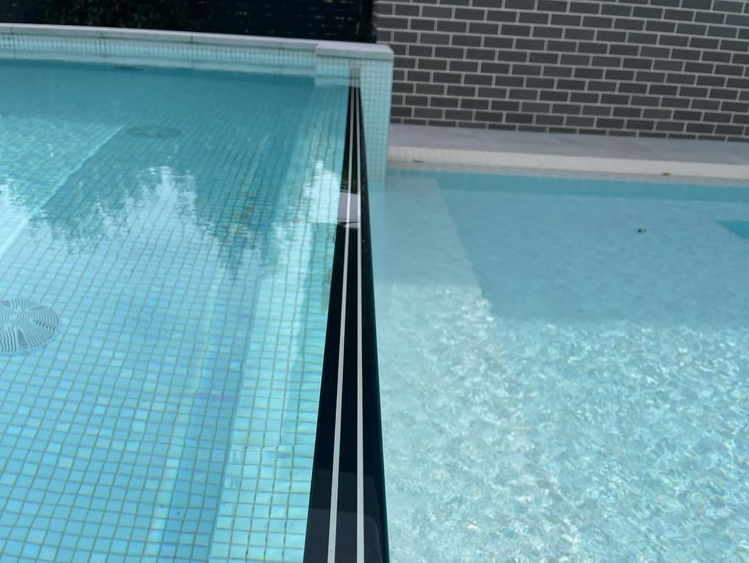 Two Pools Side by Side, One With Mosaic Tiles — All Glass Balustrading Systems in Wollongong, NSW