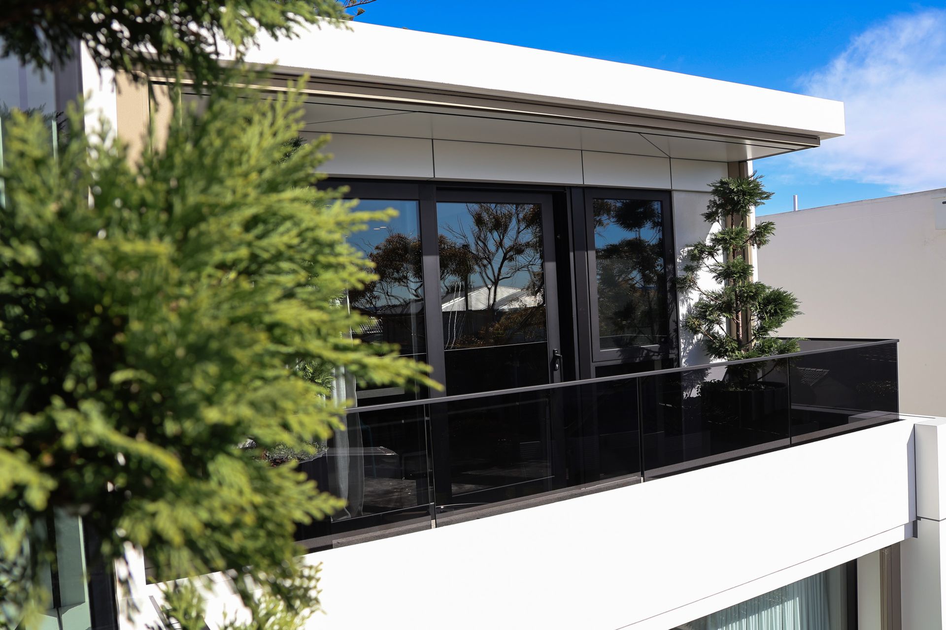 A House With A Balcony With a Glass Railing — All Glass Balustrading Systems in Wetherill Park, NSW