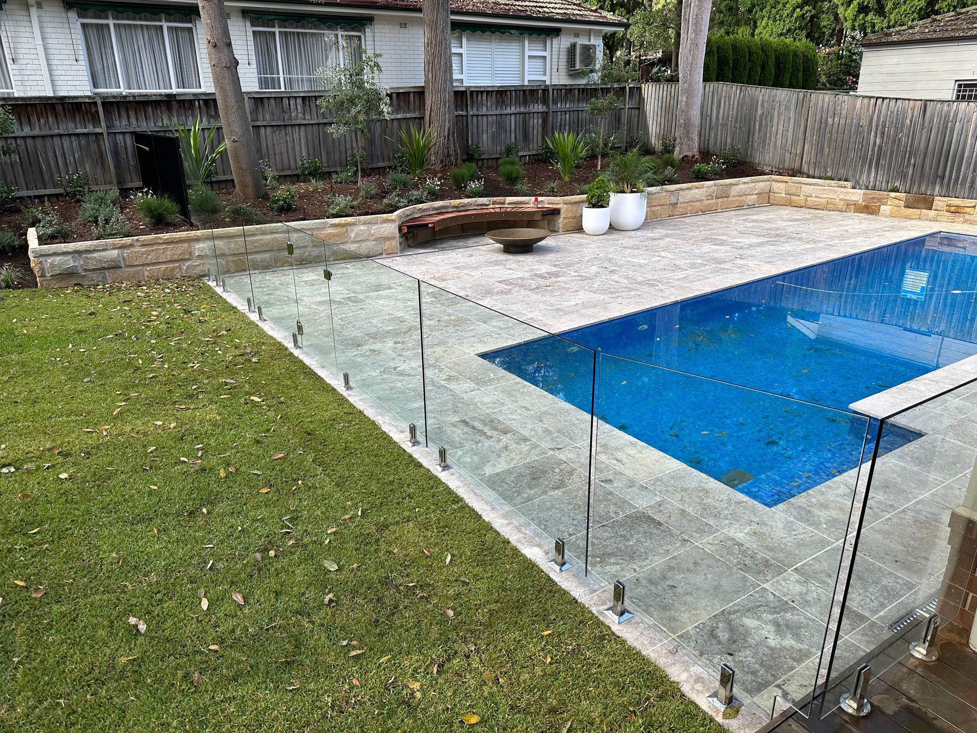A Large Swimming Pool With a Glass Fence Around It — All Glass Balustrading Systems in Mosman, NSW