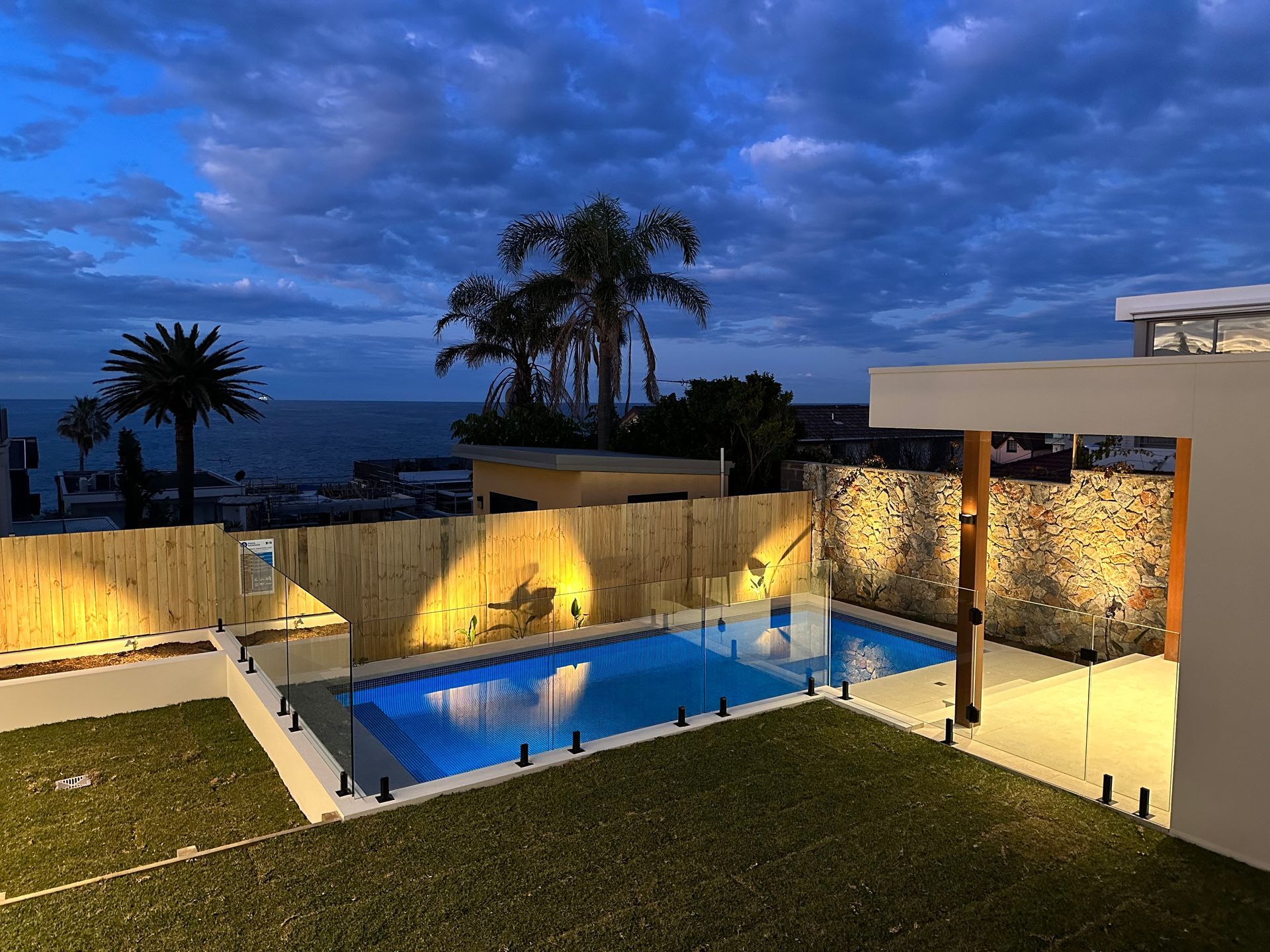 A Swimming Pool With a Glass Fence Around It — All Glass Balustrading Systems in Chatswood, NSW
