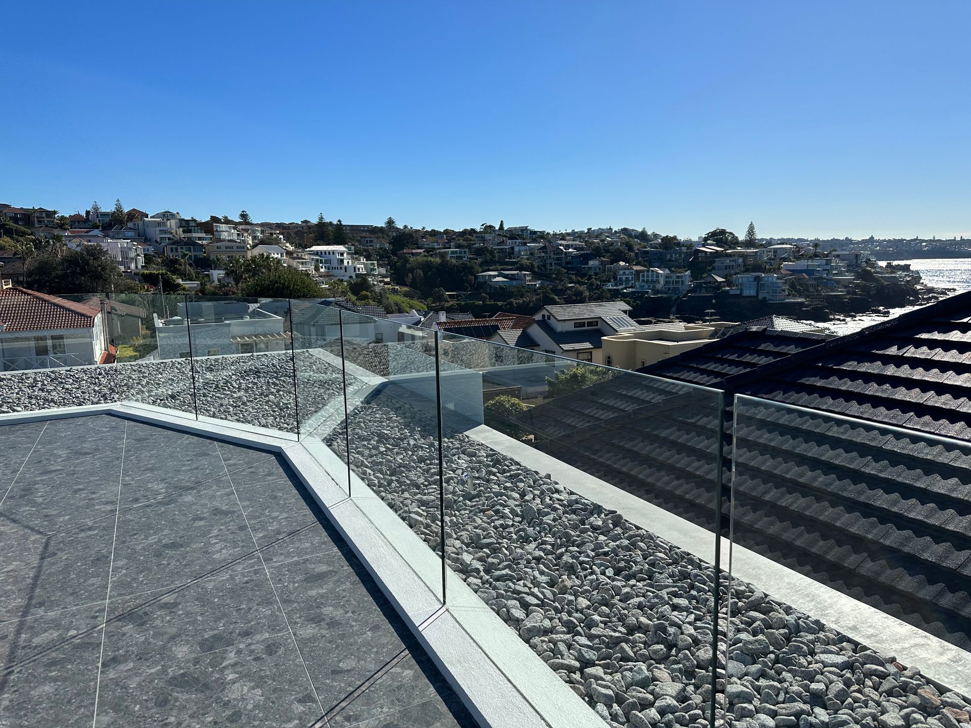 A Large House With a Swimming Pool and a Glass Railing — All Glass Balustrading Systems in Coogee, NSW