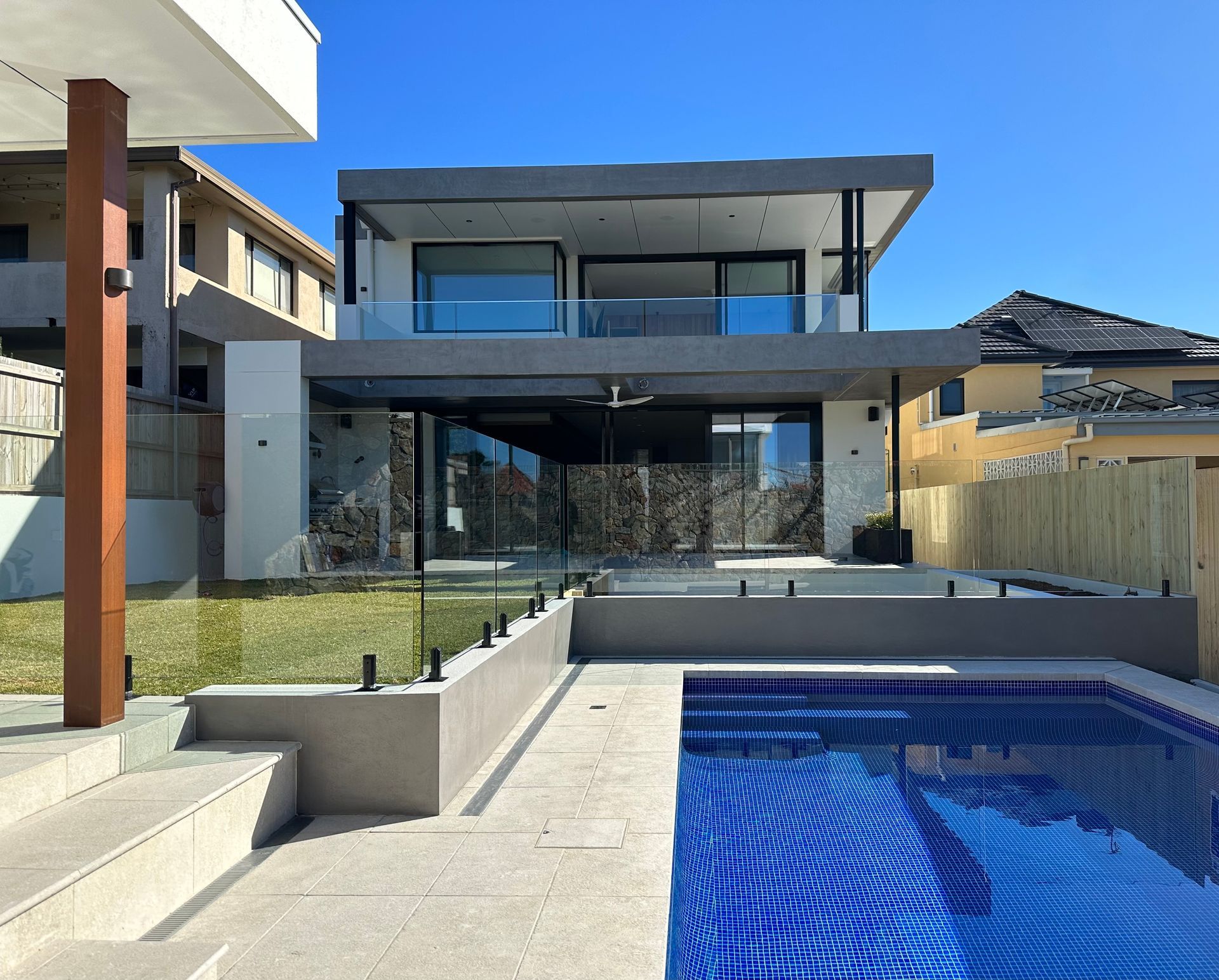 A Large House With A Pool In The Front Yard — All Glass Balustrading Systems in Wetherill Park, NSW
