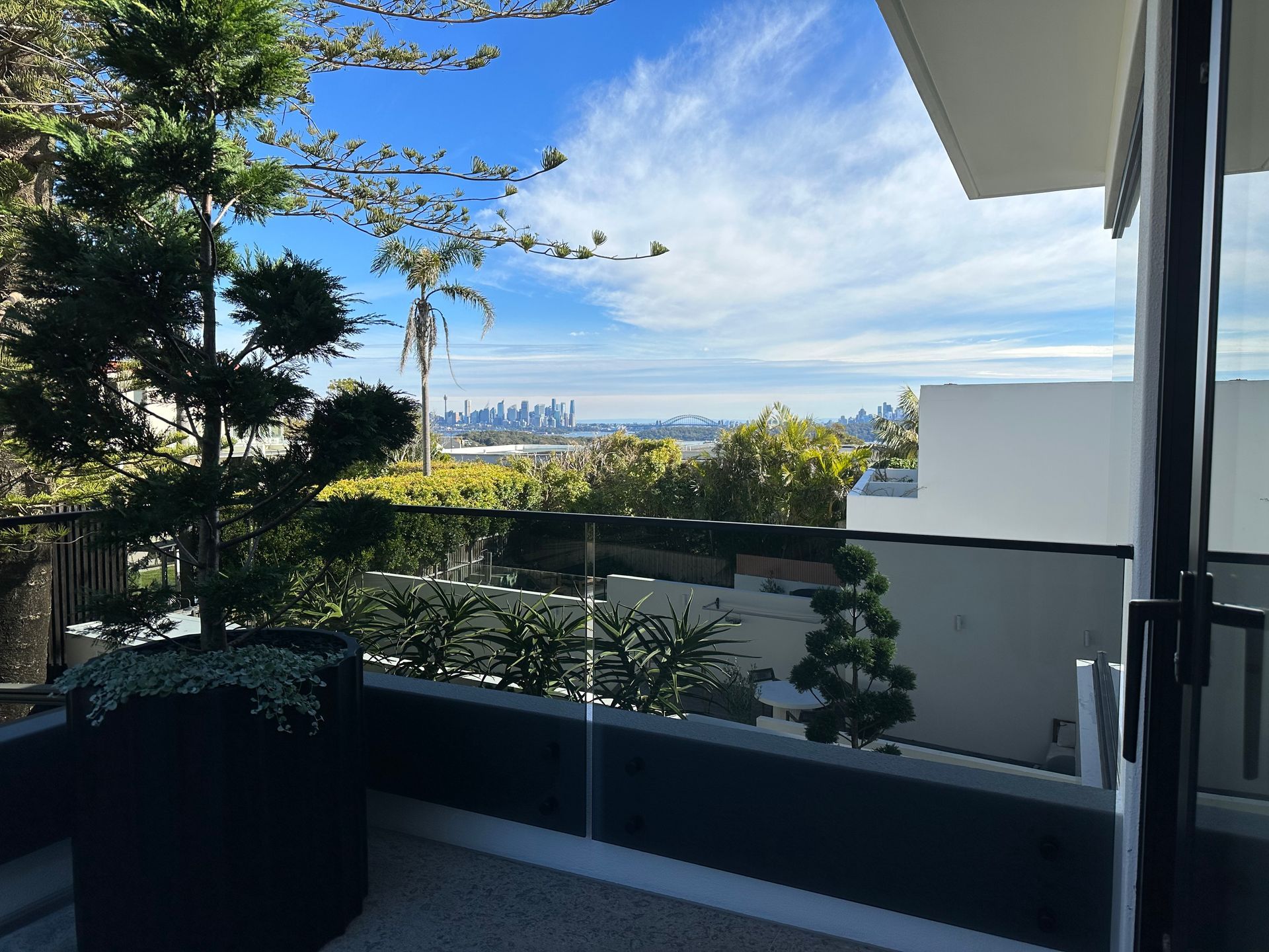 A Balcony With A Glass Fence — All Glass Balustrading Systems in Wetherill Park, NSW