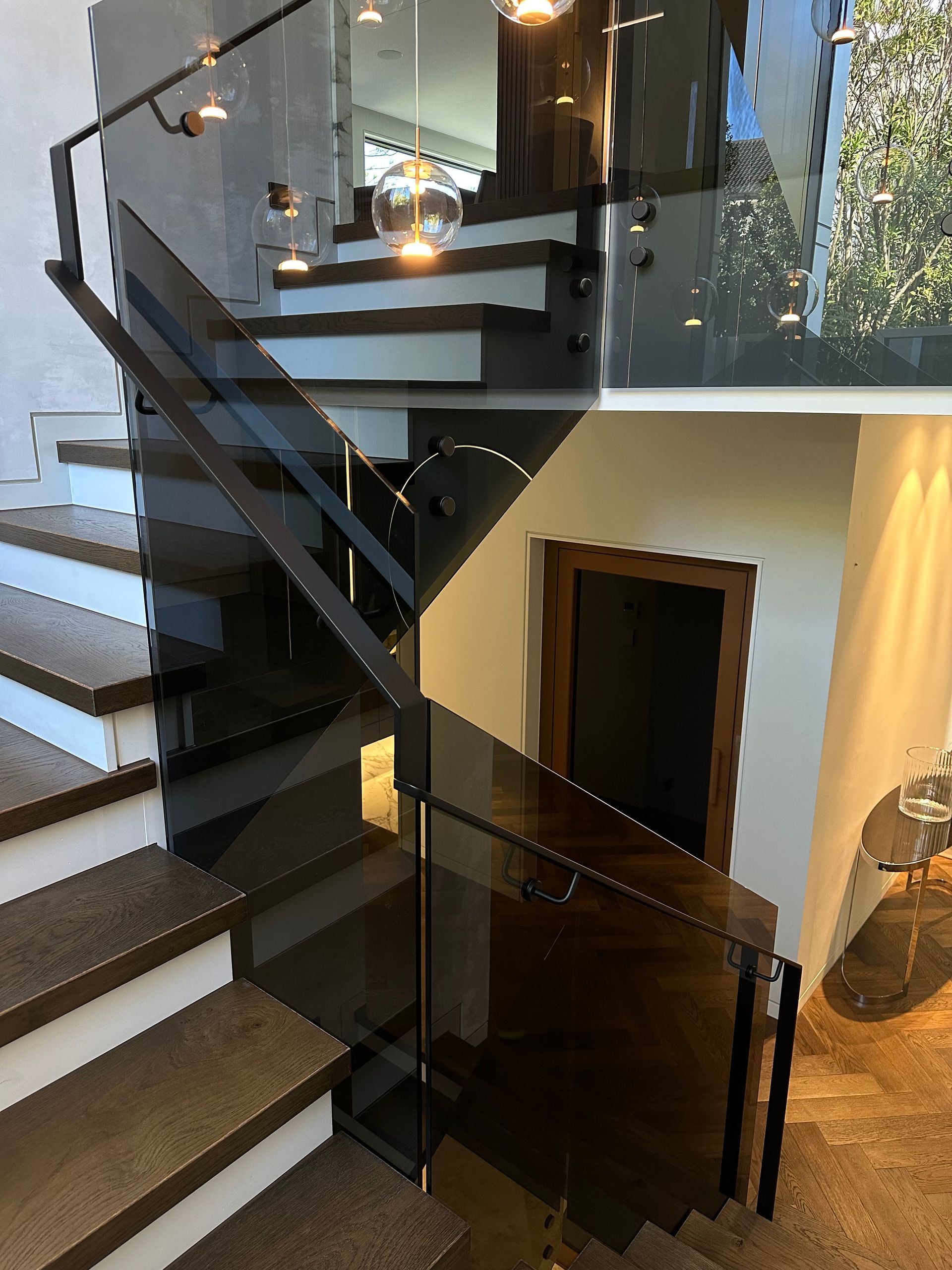 A Staircase With Wooden Steps and a Glass Railing — All Glass Balustrading Systems in Wetherill Park, NSW