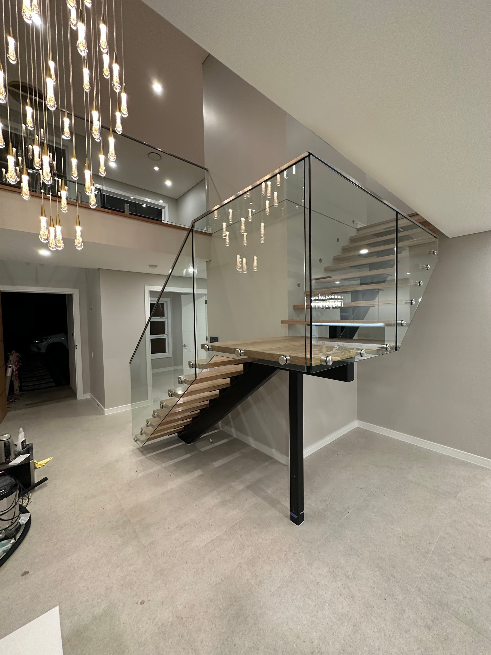 A Modern Staircase With a Curved Glass Railing — All Glass Balustrading Systems in Manly, NSW