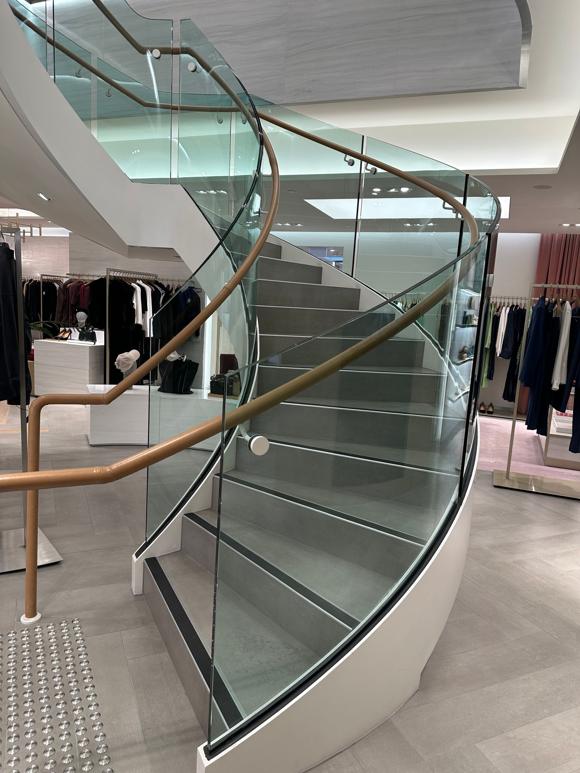 A Staircase With a Glass Railing Leading Up to a Second Floor — All Glass Balustrading Systems in Wetherill Park, NSW