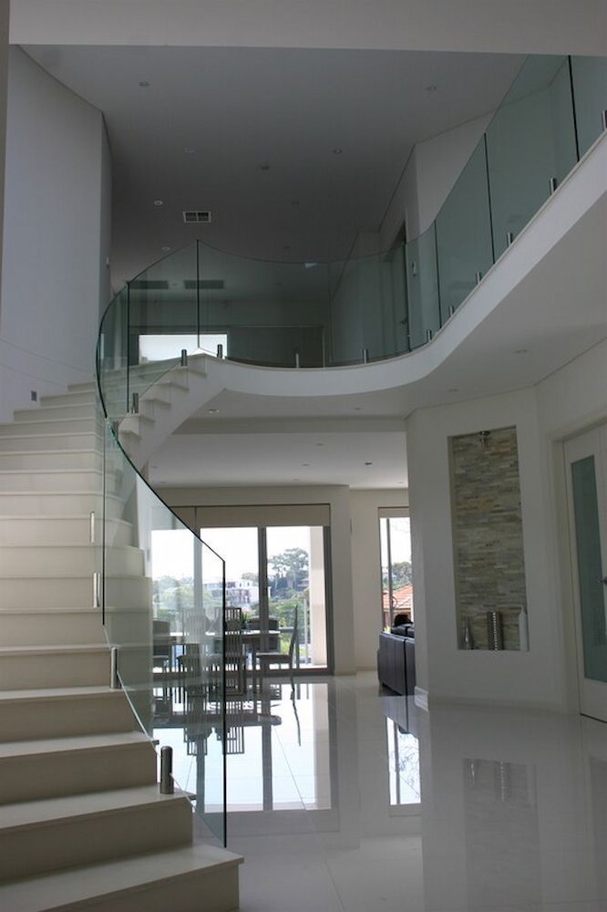 A Staircase With a Glass Railing Leading Up to the Second Floor — All Glass Balustrading Systems in Wetherill Park, NSW