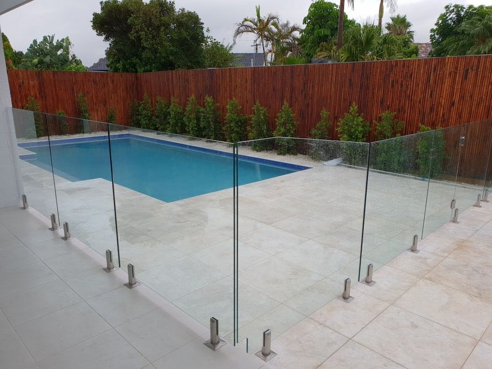 A Swimming Pool With a Glass Fence Around It — All Glass Balustrading Systems in Wetherill Park, NSW