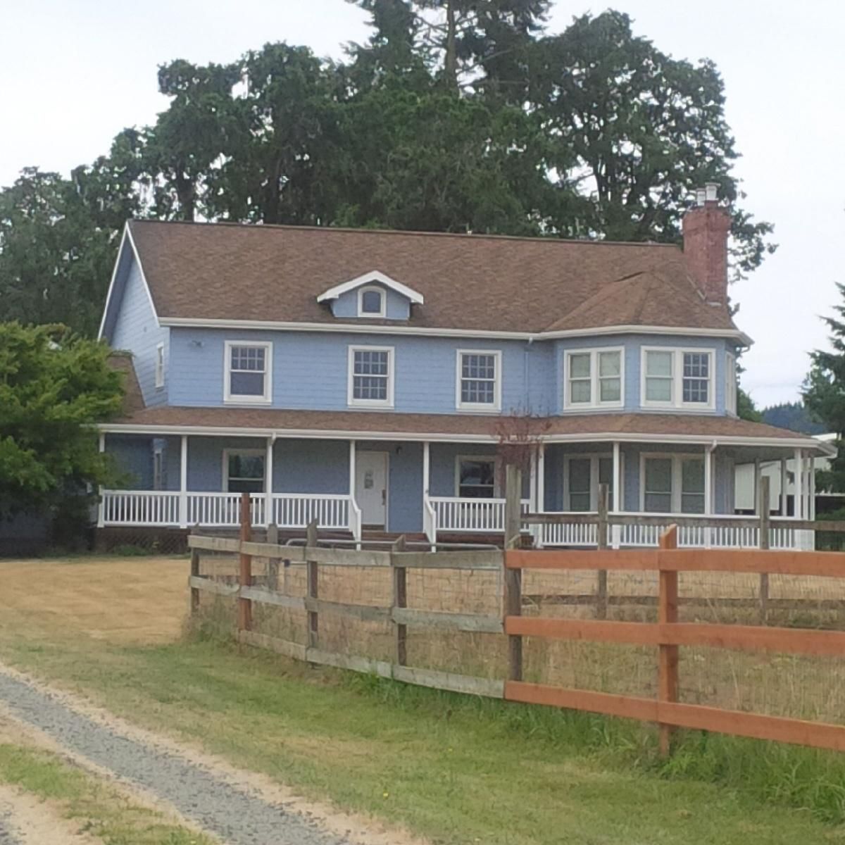 Man spraying paint on exterior of an old house – Springfield, OR - Don Ball Custom Care Painting