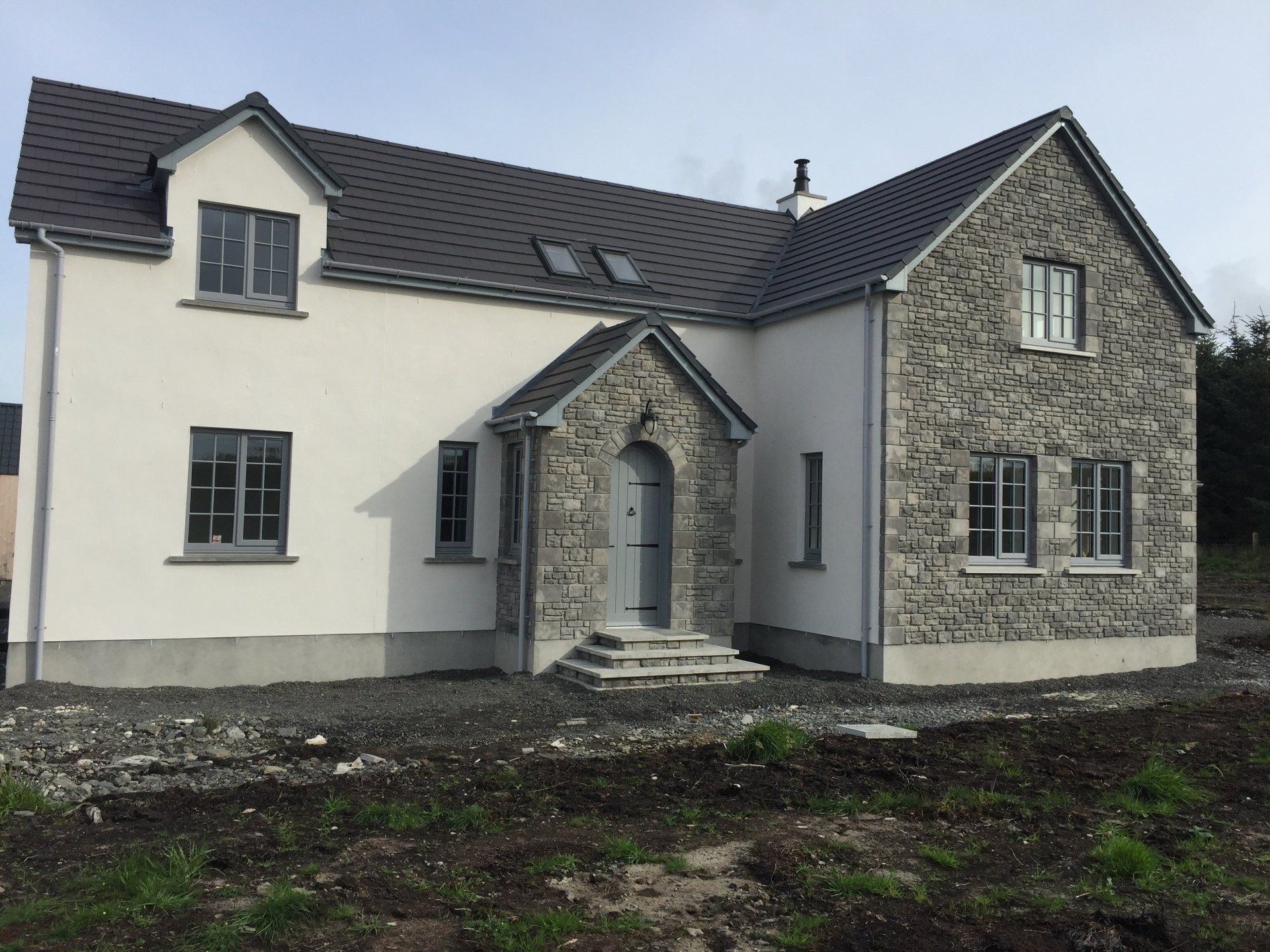 New house with K-Rend roughcasting and stonework