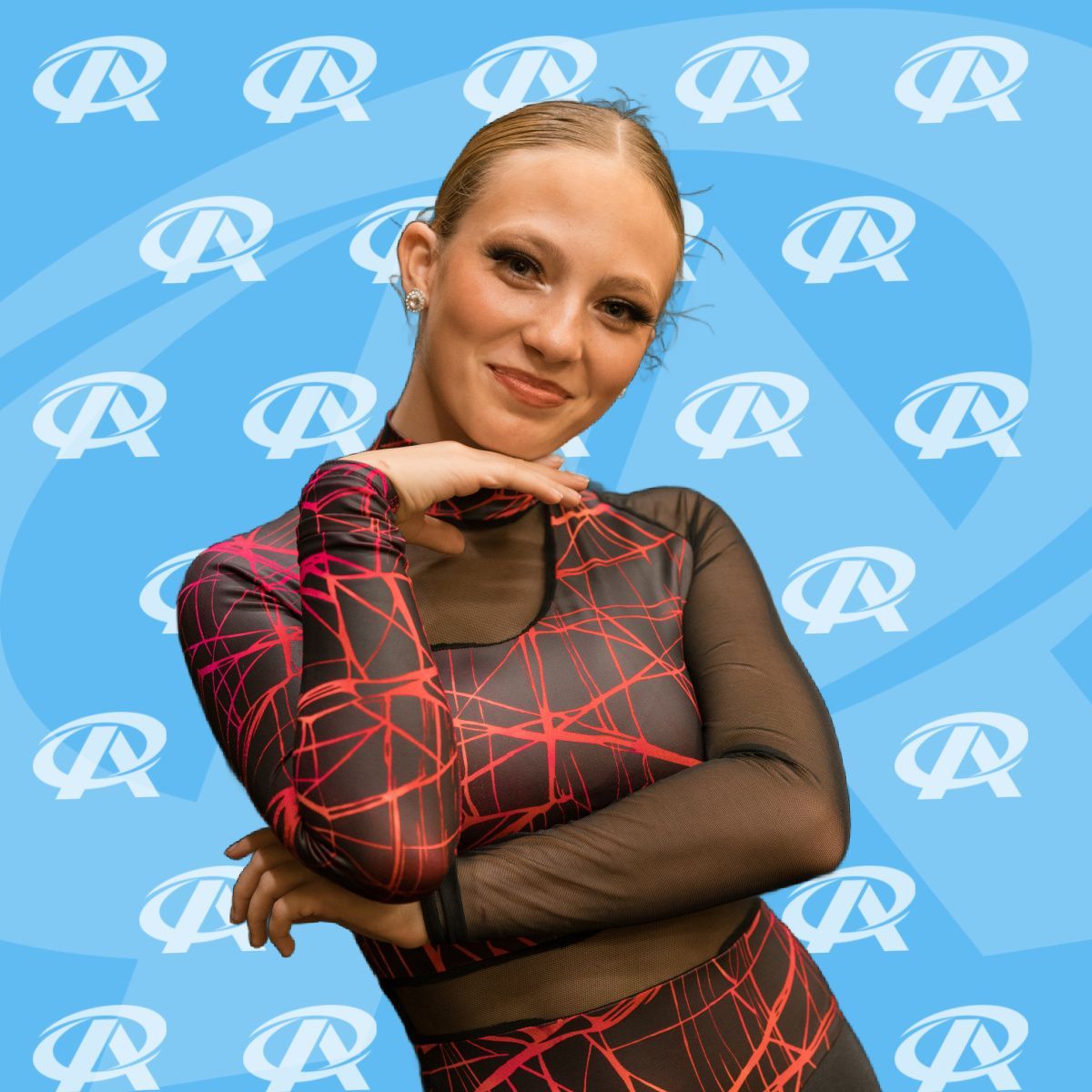 A woman in a red and black dress is standing with her arms crossed